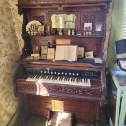 Antique pump organ items on the organ not