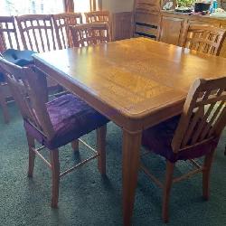 Oak dining table with eight chairs