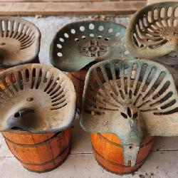 Antique Tractor Seats Mounted on Whiskey Barrels