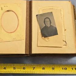 Vintage photo album including 11 tin type photos.