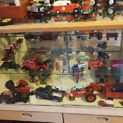 Cabinet with miscellaneous antique and collectible tractors