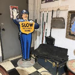 Vintage “Slow School Zone” policeman crossing guard sign with additional garage and service station 