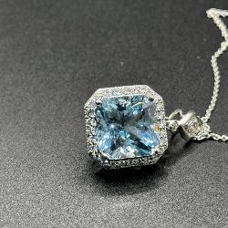 A Platinum, Aquamarine, and Diamond Halo Pendant Necklace