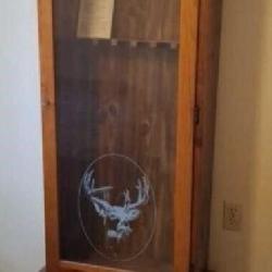 Gun cabinet holds 6 with deer logo on front. One