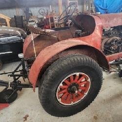 Antique Doodlebug tractor with plow
