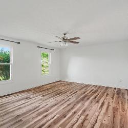 Spacious Primary Bedroom with Updated Flooring and Natural Light