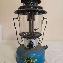 Sears Roebuck Model 476.74060 pressure lantern with blue fount, black ventilator, clear globe and Sears Roebuck and Co. decal; marked 5/65. Shows paint wear, oxidation and age-related use.