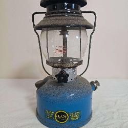 Sears Roebuck Model 476.74550 pressure lantern with blue fount, black ventilator, clear Coleman-marked globe and Sears Roebuck and Co. decal; marked 1/67. Shows paint wear, oxidation and age-related u