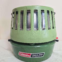 Coleman Catalytic Heater Model 515A in green with vented outer housing and label advertising 5,000–8,000 BTU output. Shows surface wear and age-related use.