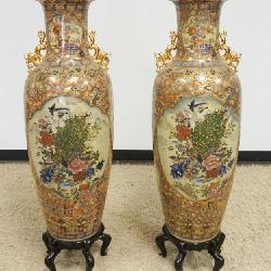 1143	PAIR OF ASIAN FLOOR URNS ON PEDESTALS EACH W/IMAGES OF PEACOCKS & BIRDS W/GILT DRAGONS ON SIDES, APPROXIMATELY 50 IN HIGH