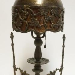 1043	BACCHUS METAL TABLE LAMP WITH ORNATE METAL MICA LINED SHADE WITH IMAGES OF BACCHUS MASK AND GRAPE VINE CLUSTERS, APPROXIMATELY 21 1/2 IN H