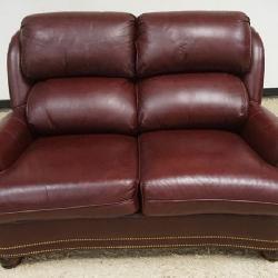 1222	HANCOCK & MOORE LEATHER LOVE SEAT W/BRASS TACK ACCENTS, SOME DISCOLORATION TO BACK TOP CUSHION, APPROXIMATELY 61 IN X 40 IN X 42 IN HIGH