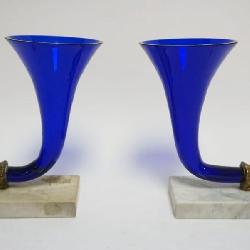 1104	PAIR OF COBALT GLASS CORNICOPIAS W/GILT METAL RAMS HEAD MOUNTED ON MARBLE BASES, EACH APPROXIMATELY 6 IN X 3 IN X 8 IN HIGH