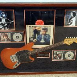 1160	BOB DYLAN COLLAGE IN SHADOW BOX FRAME INCLUDING ALBUM *HIGHWAY 61 REVISITED* PHOTOS, CDS & A FENDER MUSTANG GUITAR W/ATTRIBUTED SIGNATURES, APPROXIMATELY 44 IN X 37 IN X 4 IN OVERALL