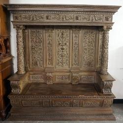 HEAVILY CARED HOODED CONTINENTIAL HALL BENCH WITH LIFT TOP SEAT. CARVED ALL OVER COLUMNS AND PANELS, APPROXIMATELY 71 IN X 21 IN X 75 IN H