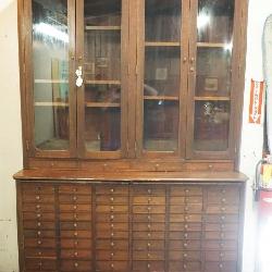 1235	ANTIQUE MAHOGANY COUNTRY 2 PIECE STORE APOTHECARY CABINET, TOP HAVING 4 GLASS DOORS & BASE HAVING 72 DRAWERS & 2 PULL OUT SURFACES, APPROXIMATELY 60 IN X 22 IN X 96 IN
