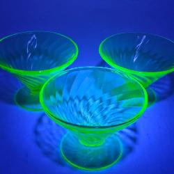 Three Anchor Hocking Green Uranium footed Sherbert glassware and one vintage green Indiana glass bow