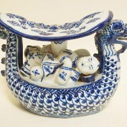 1043	ASIAN BLUE & WHITE PORCELAIN DRAGON PILLOW, CHARACTER MARKS ON BASE, APPROXIMATELY 9 IN X 4 IN X 6 IN