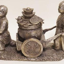 1062	METAL FIGURE OF *WEALTH BOY*, APPROXIMATELY 9 IN X 4 IN X 6 1/2 IN HIGH